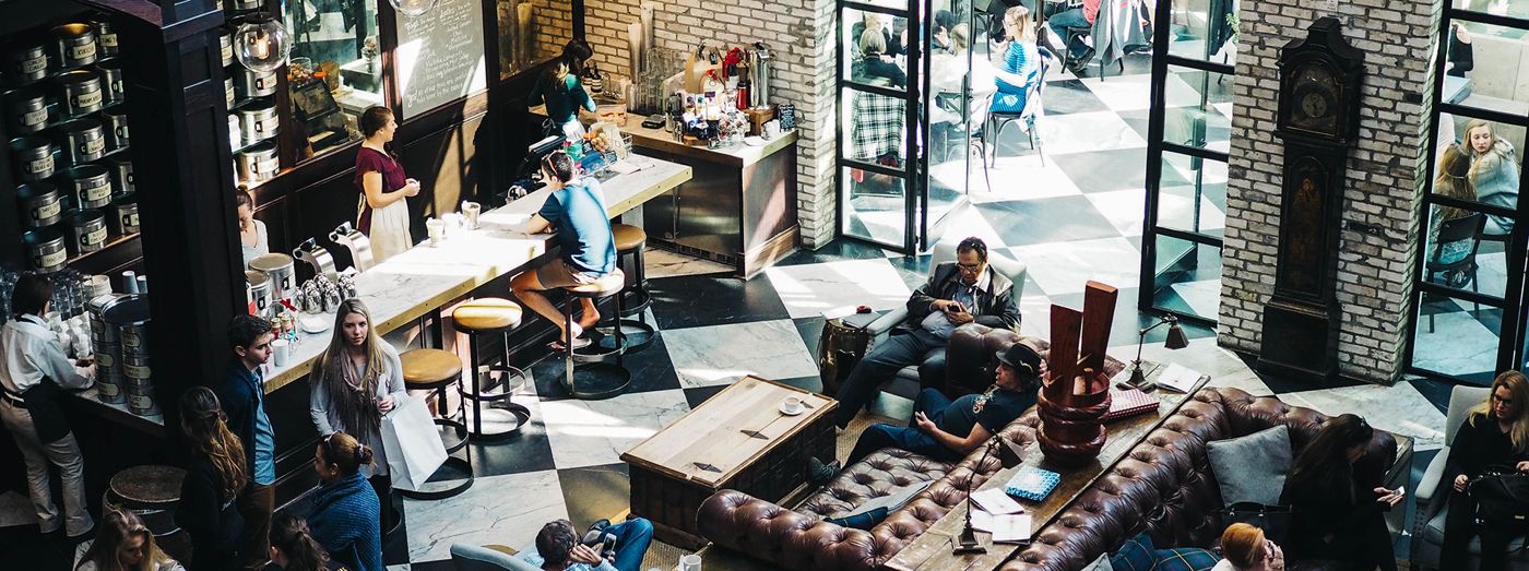 Busy cafe interior with customers seated at tables