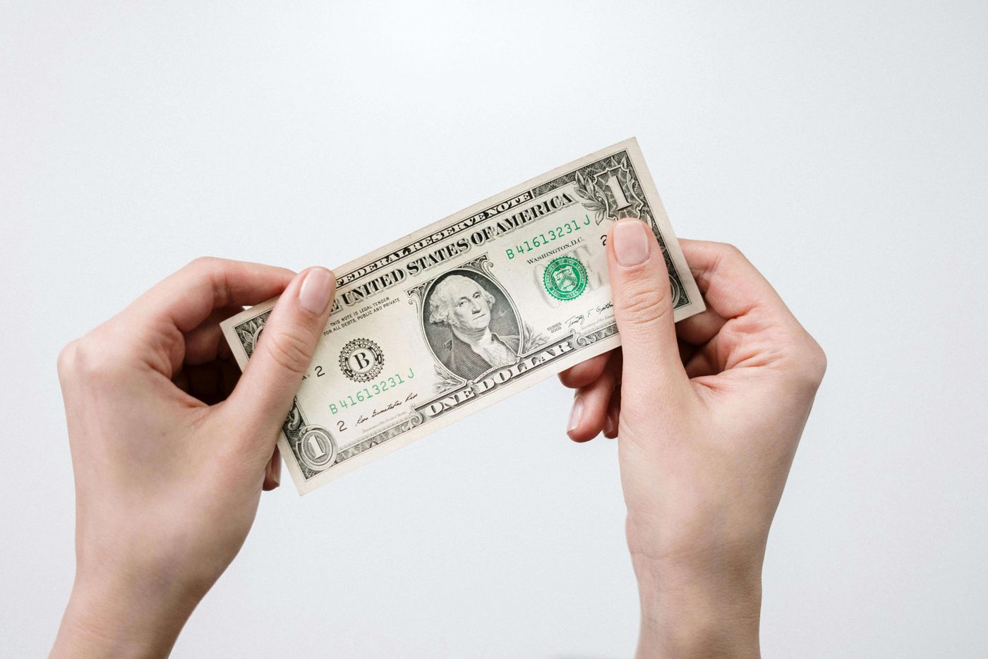 Two hands holding a banknote, representing vehicle and equipment finance