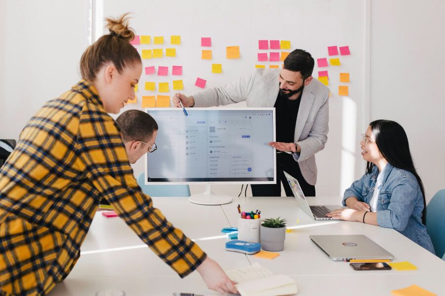 Small team planning content in front of a monitor